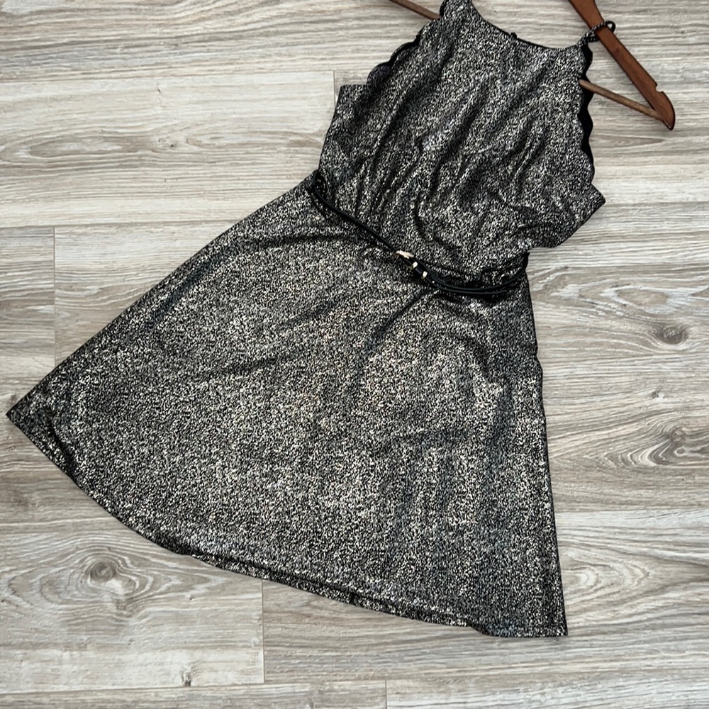 Gorgeous black and gold dress with scalloped details on arm openings.
